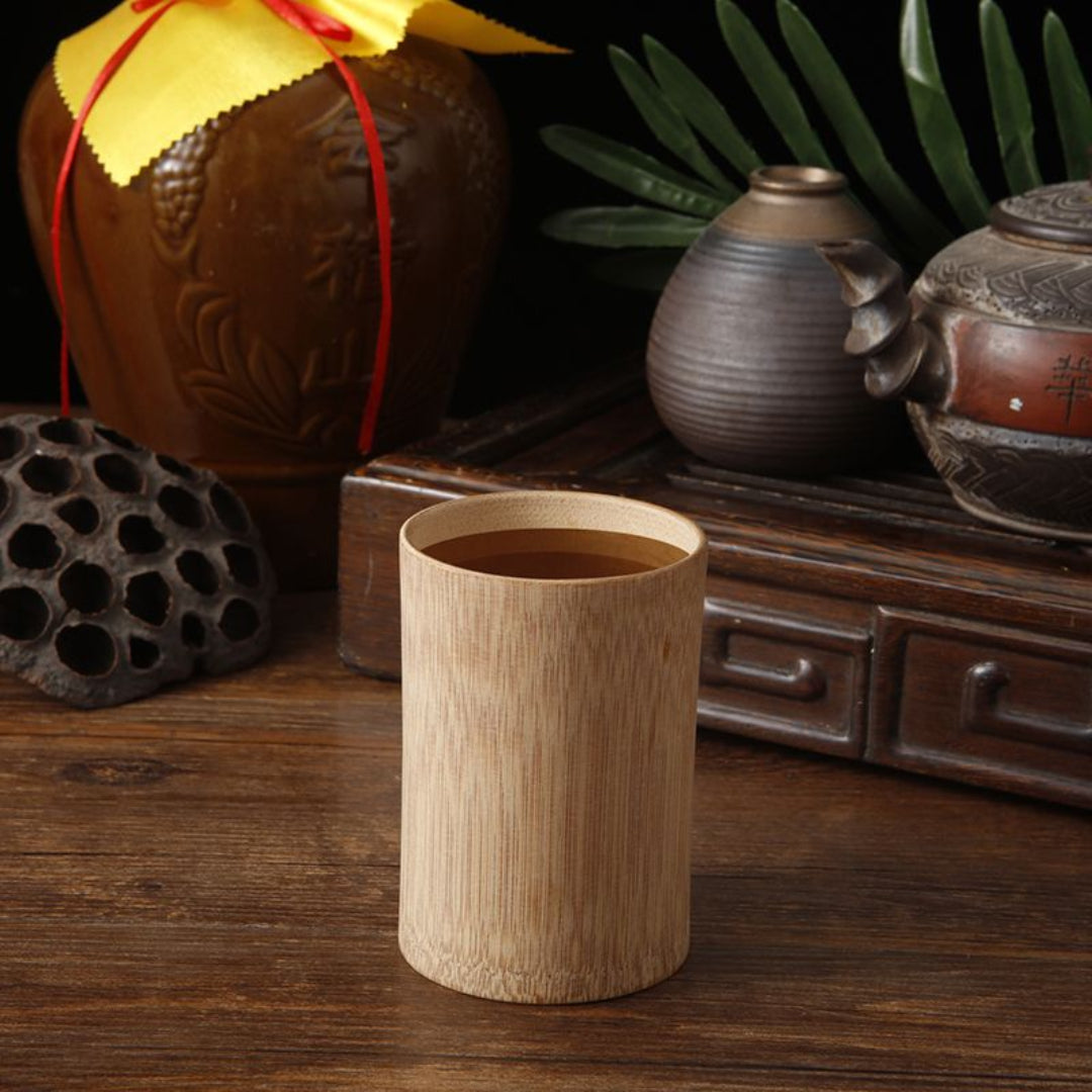Wooden cup on a wooden surface with decorative items in the background