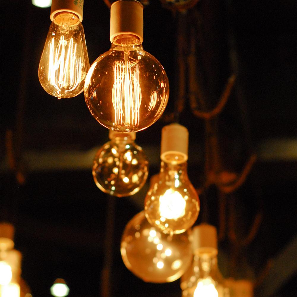 Vintage-style light bulbs hanging against a dark background