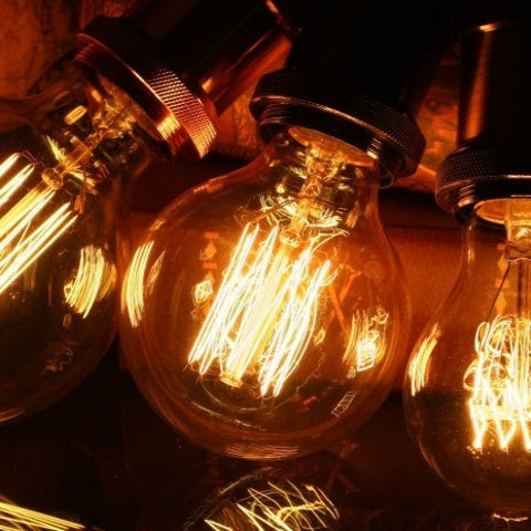 Vintage-style light bulbs with visible filaments on a dark background