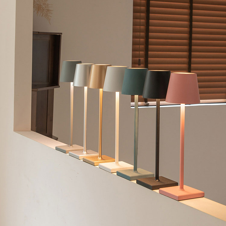 Row of colorful table lamps on a neutral background