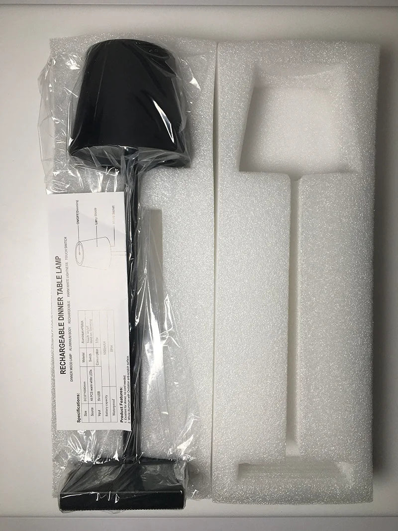 Black lamp with packaging and documentation on a white background