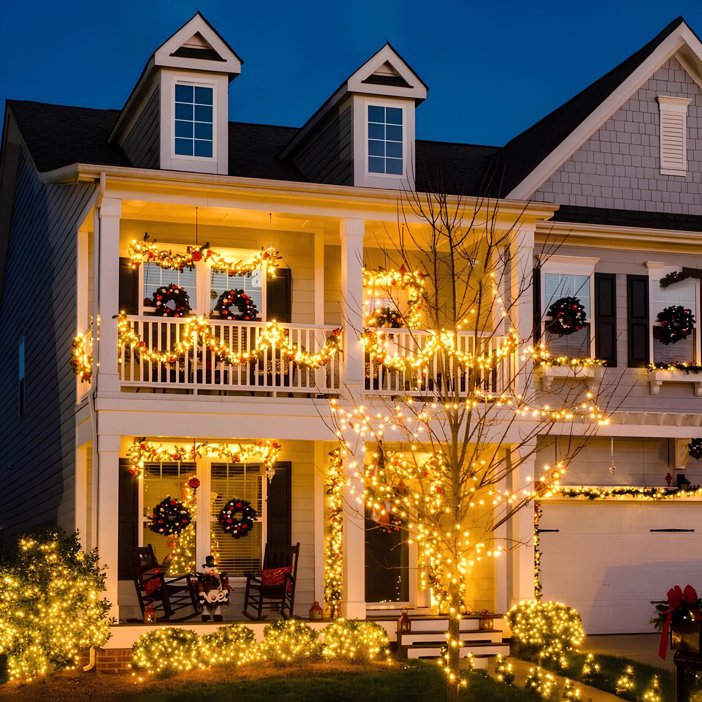 Decorated house exterior with Christmas lights and wreaths at night.