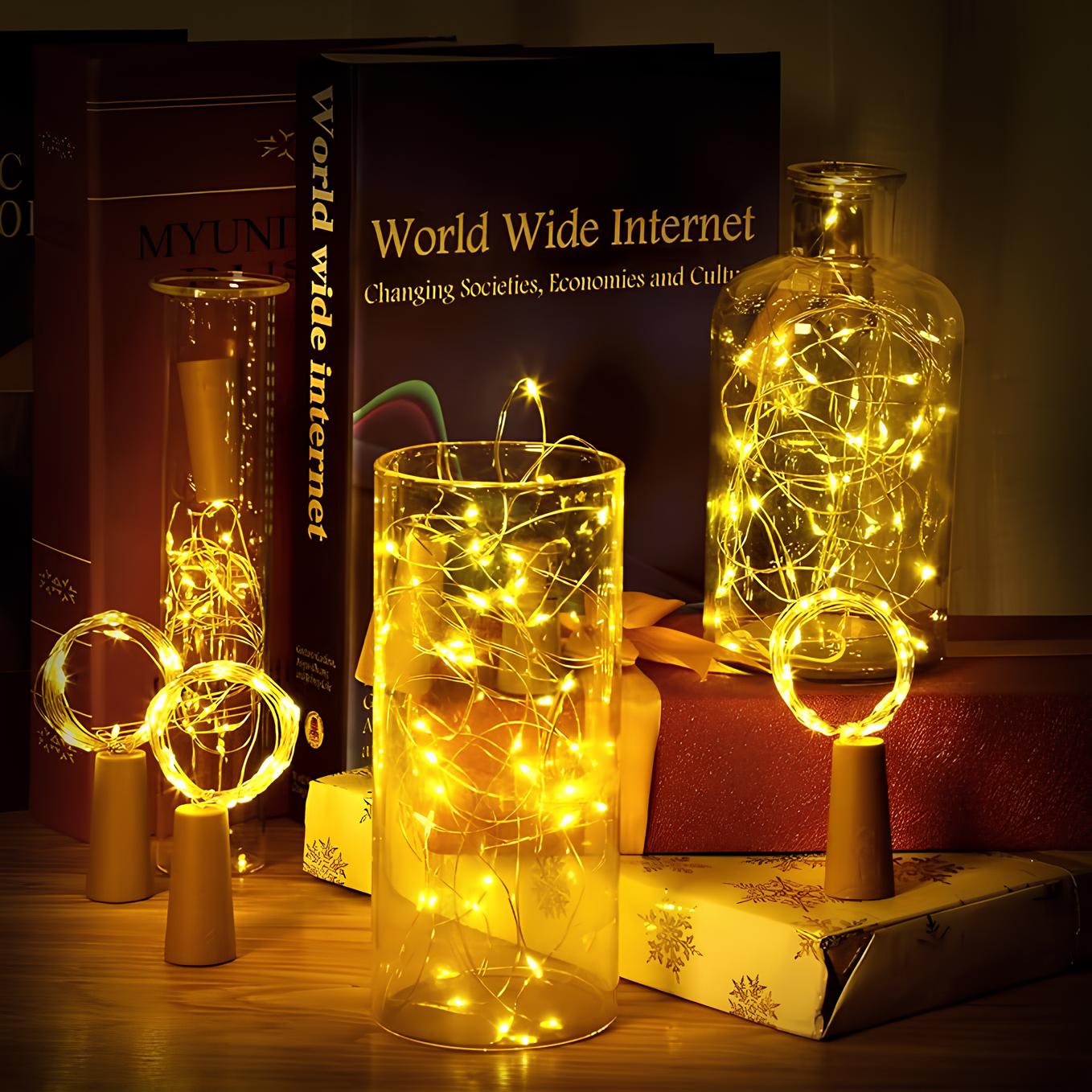 Decorative string lights in glass jars on a wooden surface with books in the background