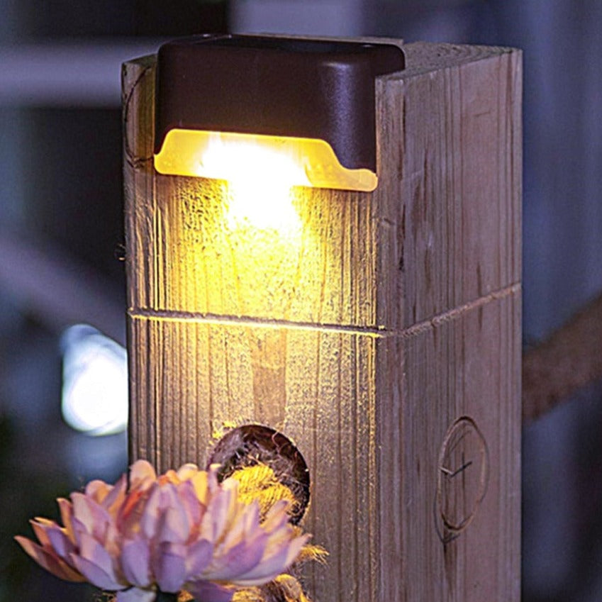 Wooden outdoor light fixture with a glowing bulb, blurred background