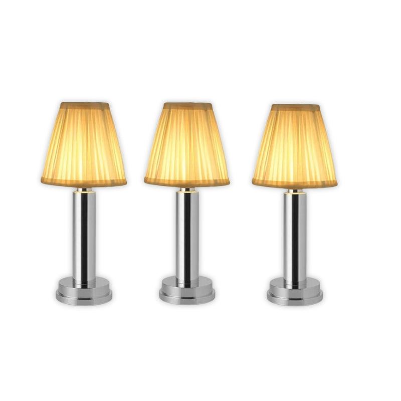 Three table lamps with gold lampshades on a white background