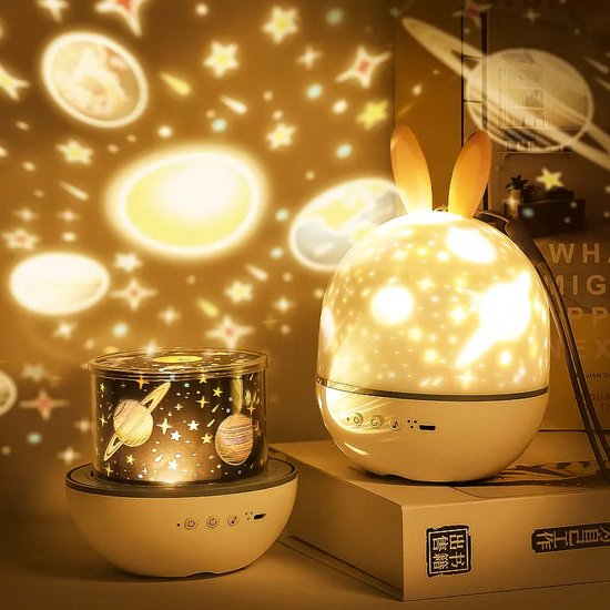 Two night lights, one shaped like a rabbit and the other with space-themed design, casting starry patterns on a wall.