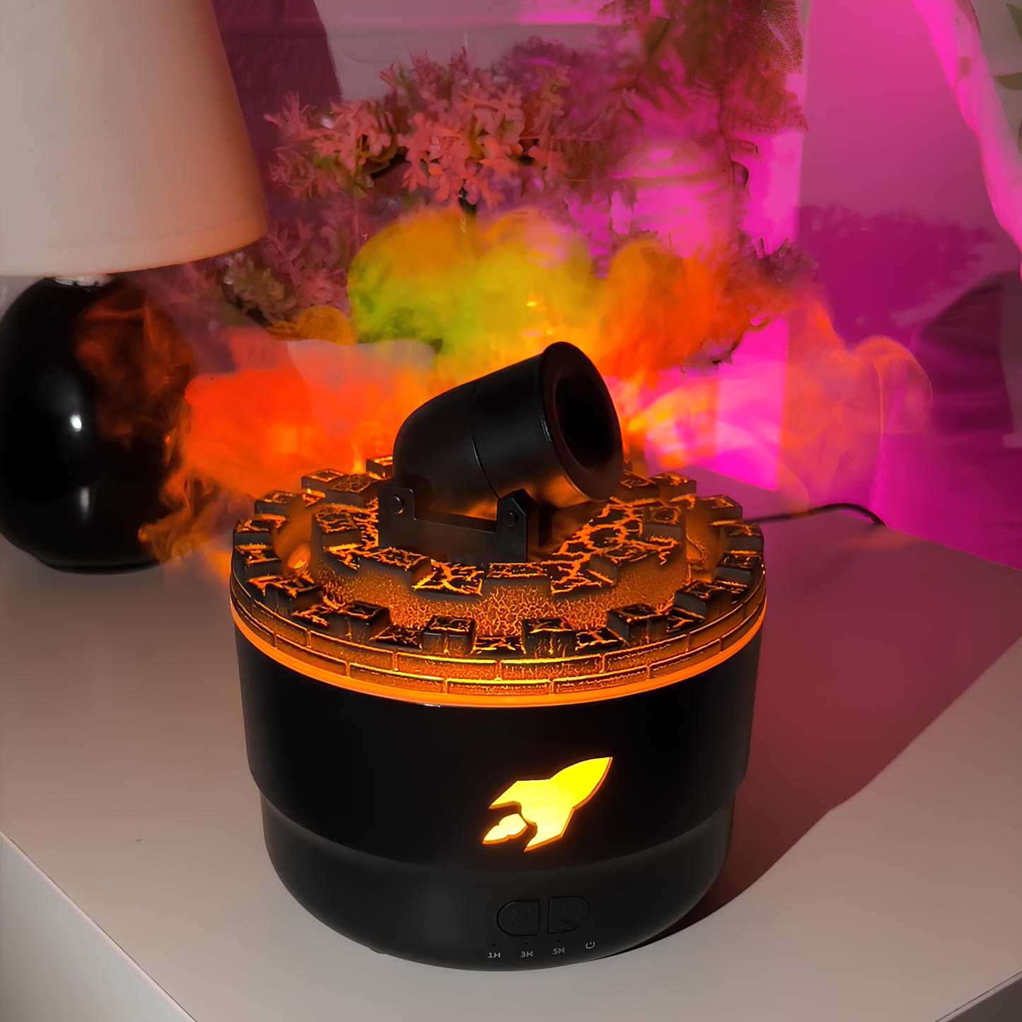 Black and orange diffuser emitting colorful smoke on a white surface with a blurred background