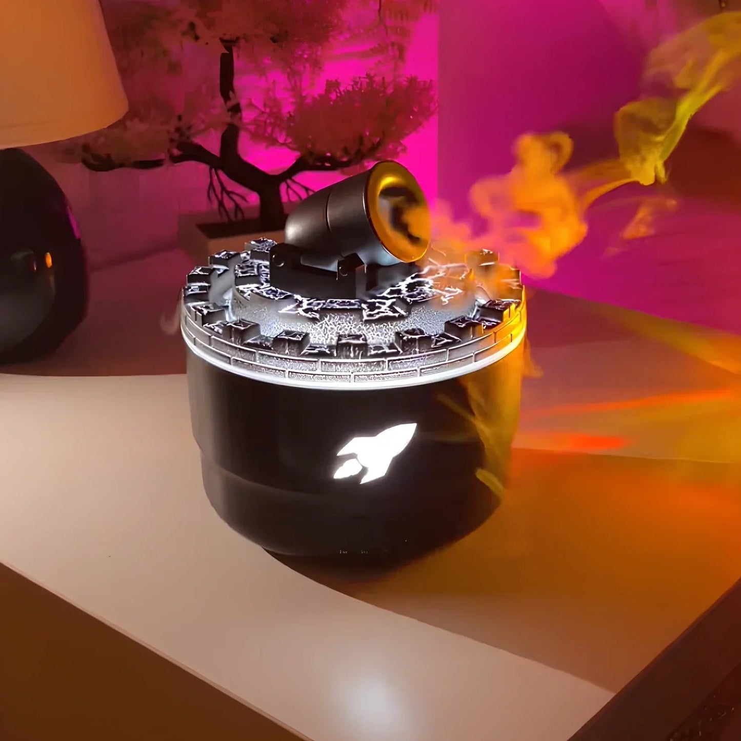 Black and yellow device emitting colorful flames on a pink background