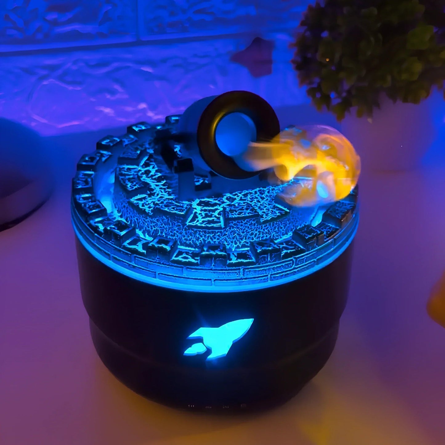 Decorative item with rocket design and blue light on a white surface.