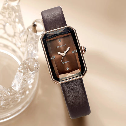 Brown watch with a textured strap on a beige background