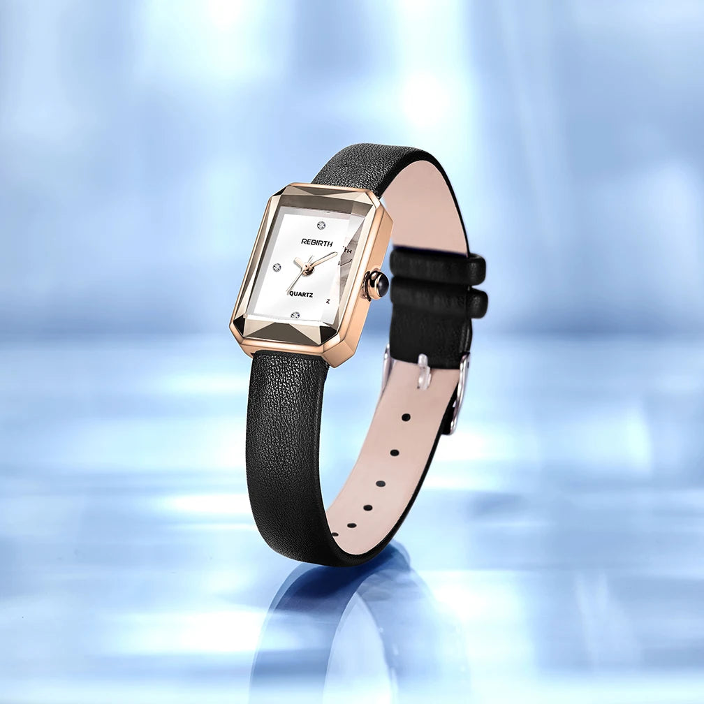 Wristwatch with black strap and rose gold case on a reflective blue surface