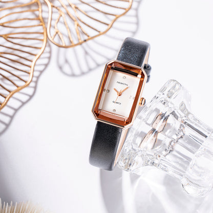 Luxury watch with a black strap and gold accents on a white background