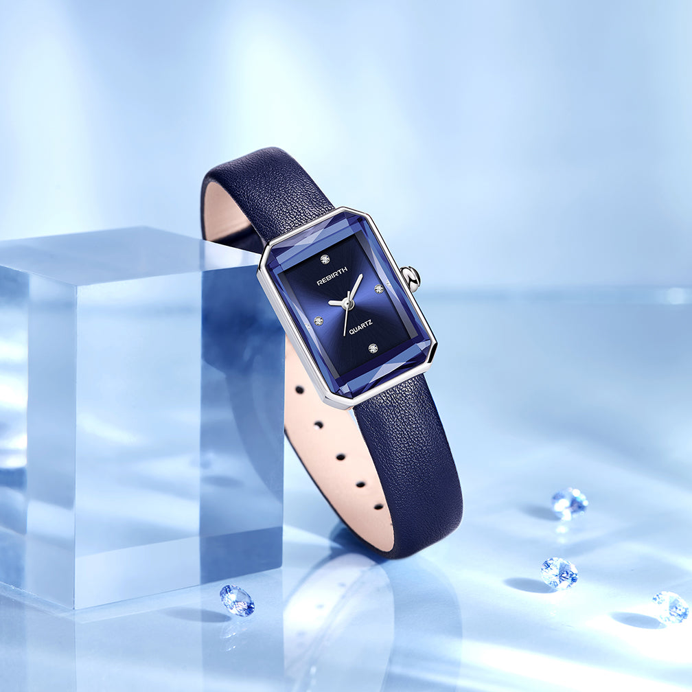 Blue watch with a rectangular face on a reflective blue surface
