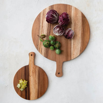 Josh & Tate - Arbor Round Wooden Board - Two wooden cutting boards with vegetables on a light gray background
