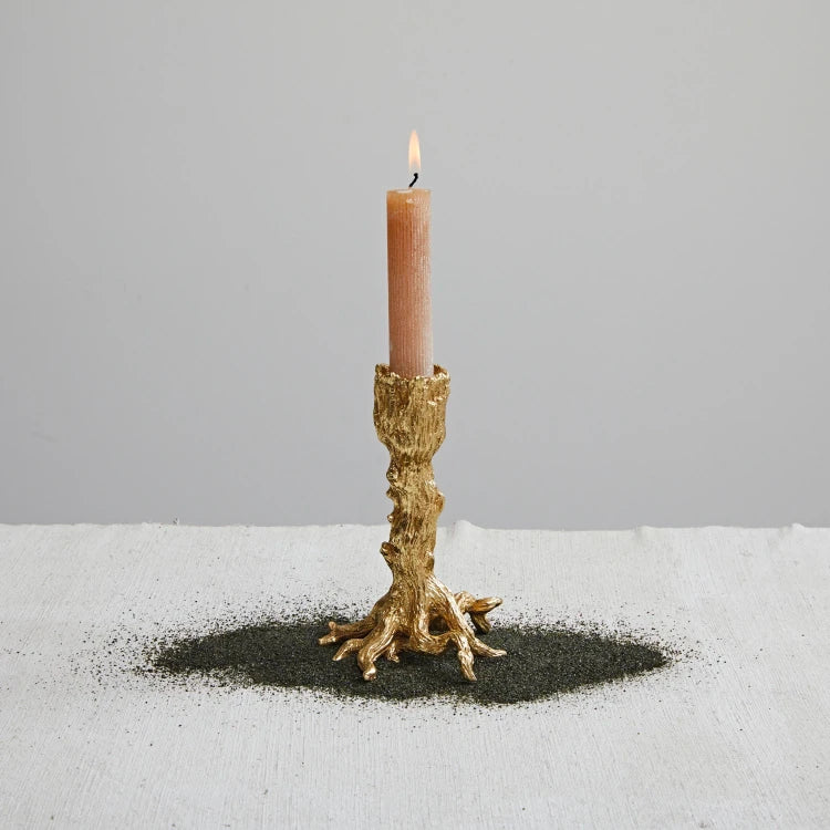 Josh & Tate - Artemis Taper Candle Stand - Set of 2 - Candle in a decorative gold holder on a gray background