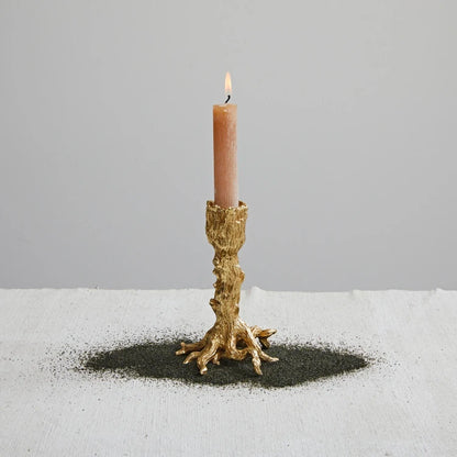 Josh & Tate - Artemis Taper Candle Stand - Set of 2 - Candle in a decorative gold holder on a gray background