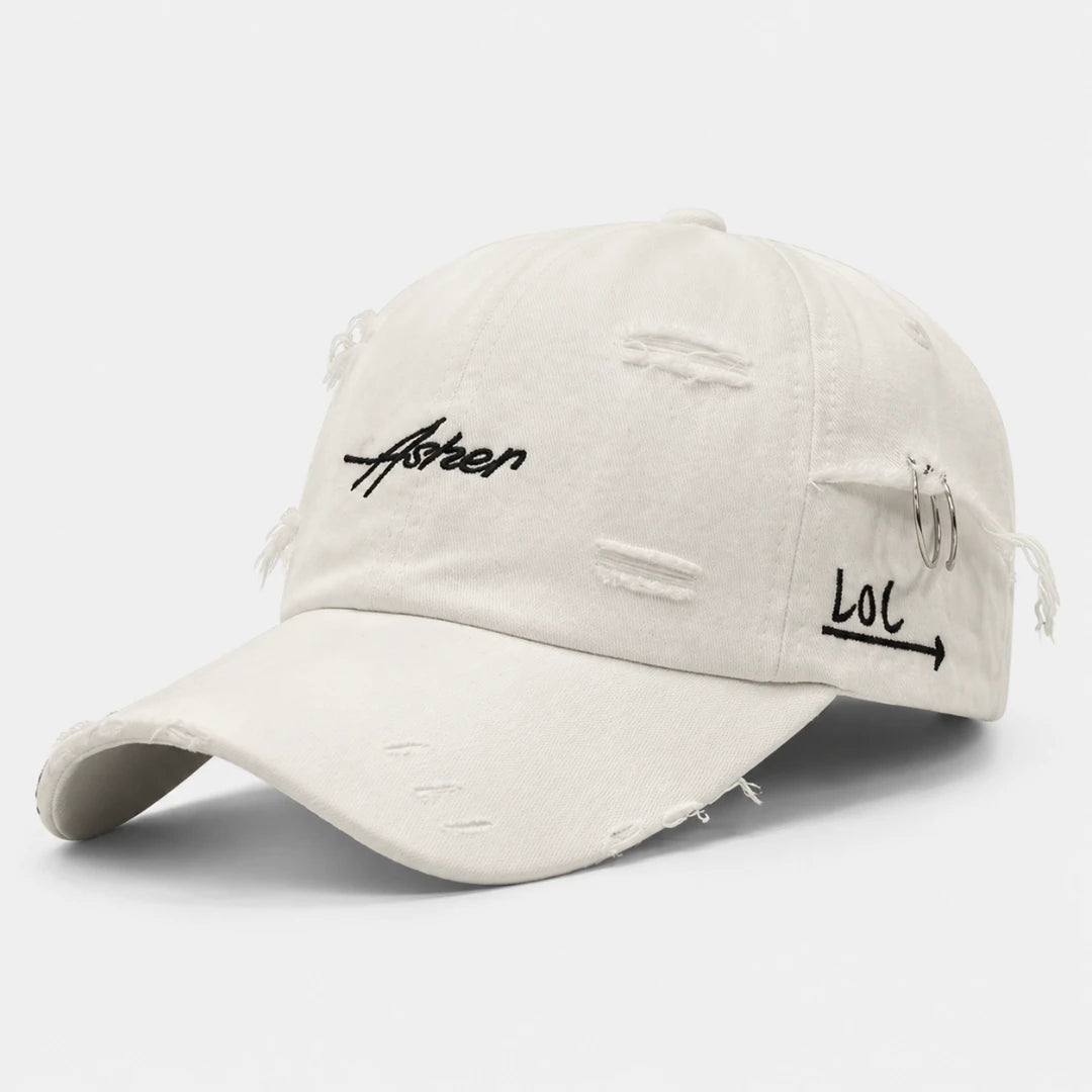 Josh & Tate - AsherLOL™ Distressed Cap - An off-white distressed baseball cap with black embroidered text reading 'faken' on the front and 'lol' with an arrow on the side, shown on a light gray background.
