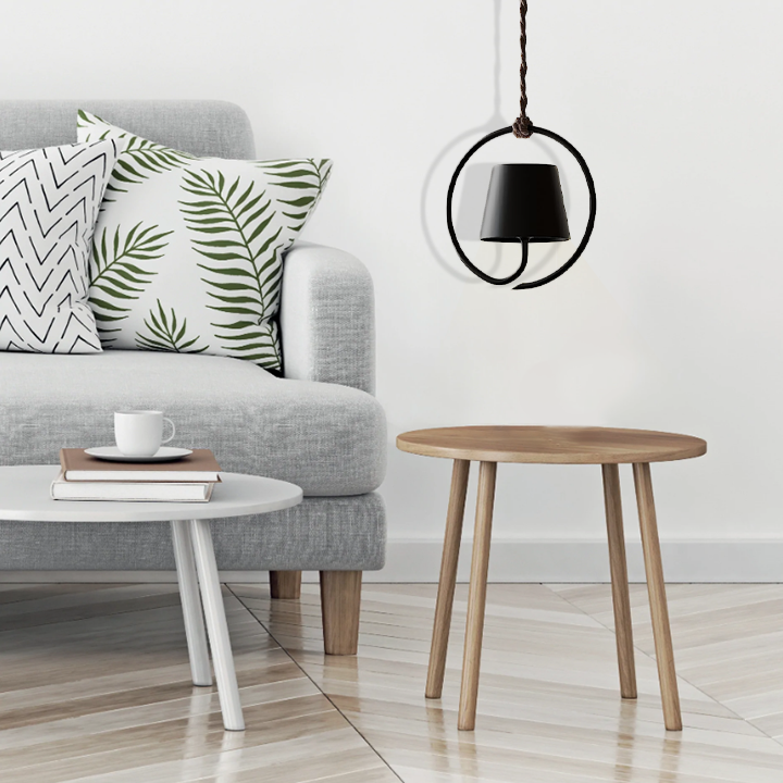 Modern living room with gray sofa, wooden side table, and pendant light.
