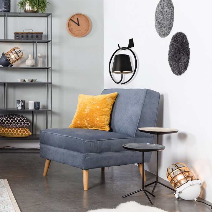Gray sofa with a yellow pillow in a modern living room setting.