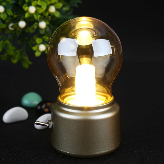 Decorative light bulb with a gold base on a dark background