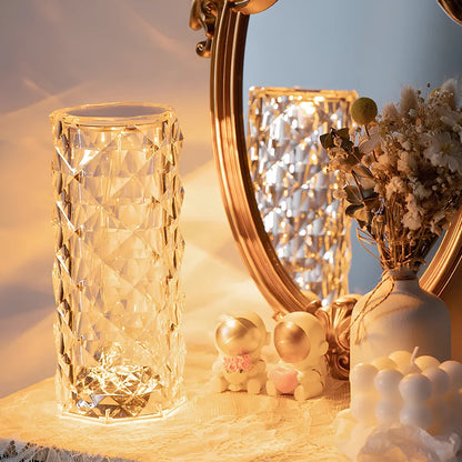 Decorative items including a textured glass vase, small figurines, and a mirror on a surface.