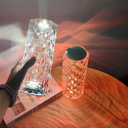 Two decorative vases on a table with a warm glow