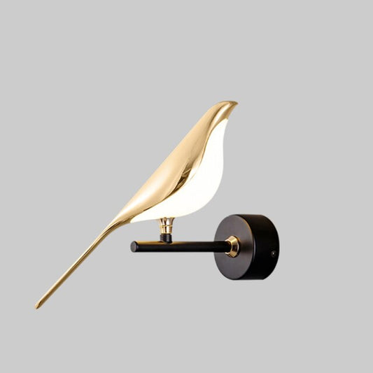 Modern wall light fixture with gold bird-shaped design on a gray background