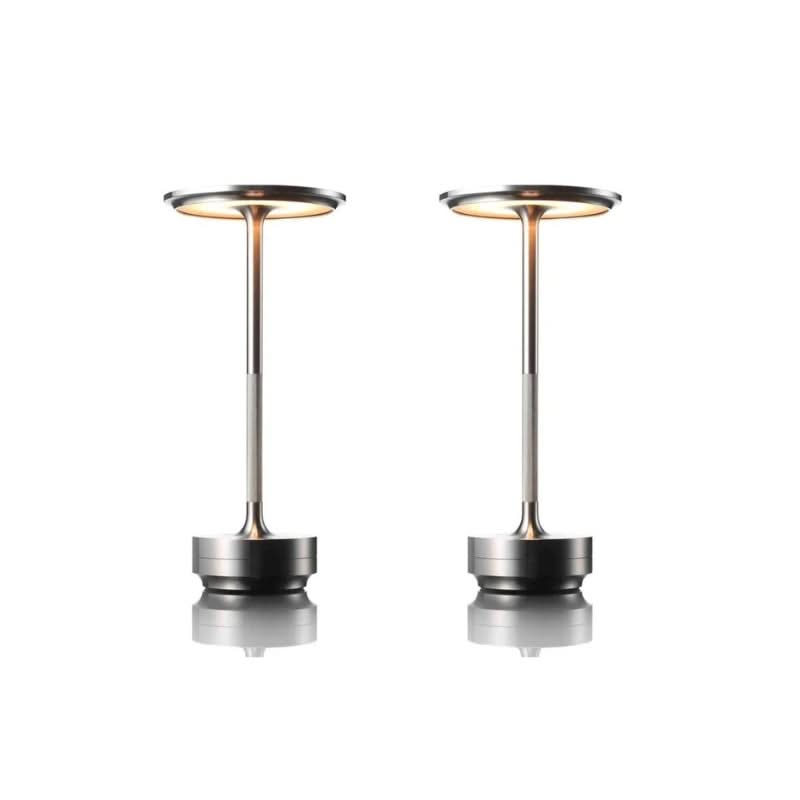 Two metallic outdoor heaters on a white background