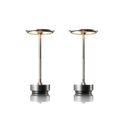 Two metallic outdoor heaters on a white background