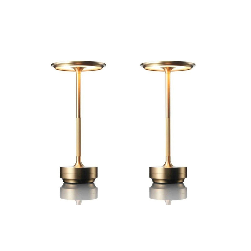 Two gold-colored lamps on a white background