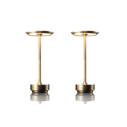 Two gold-colored lamps on a white background