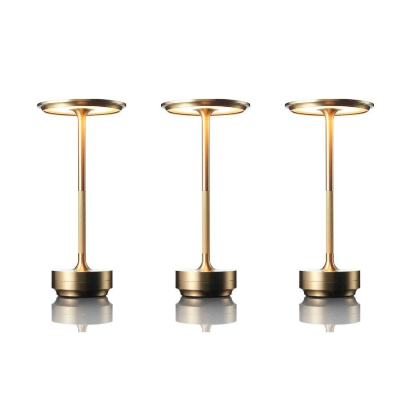 Three gold-colored lamps on a white background