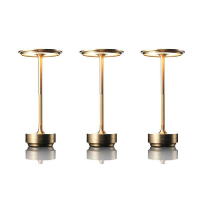 Three gold-colored lamps on a white background