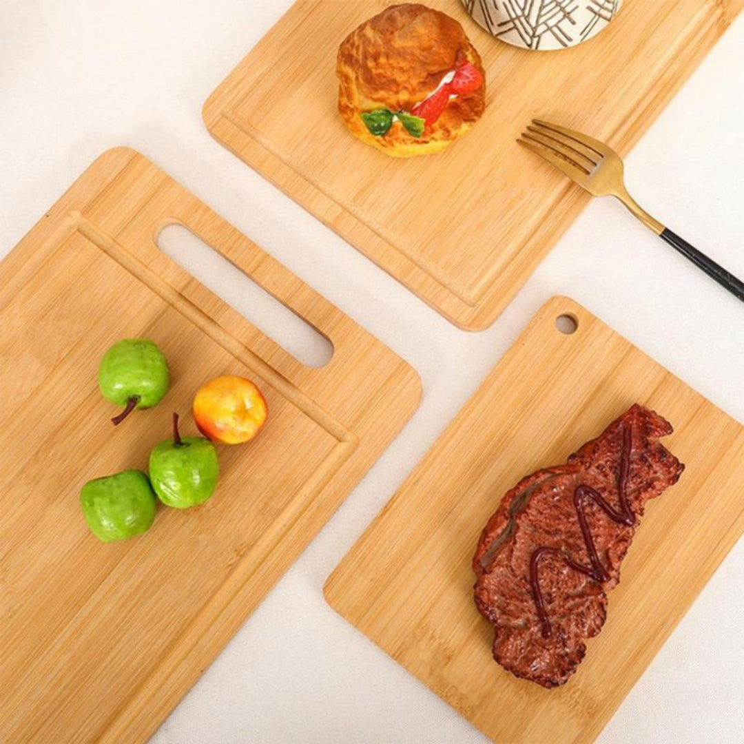 Three wooden cutting boards with food items on a white surface