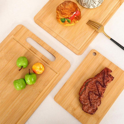 Three wooden cutting boards with food items on a white surface