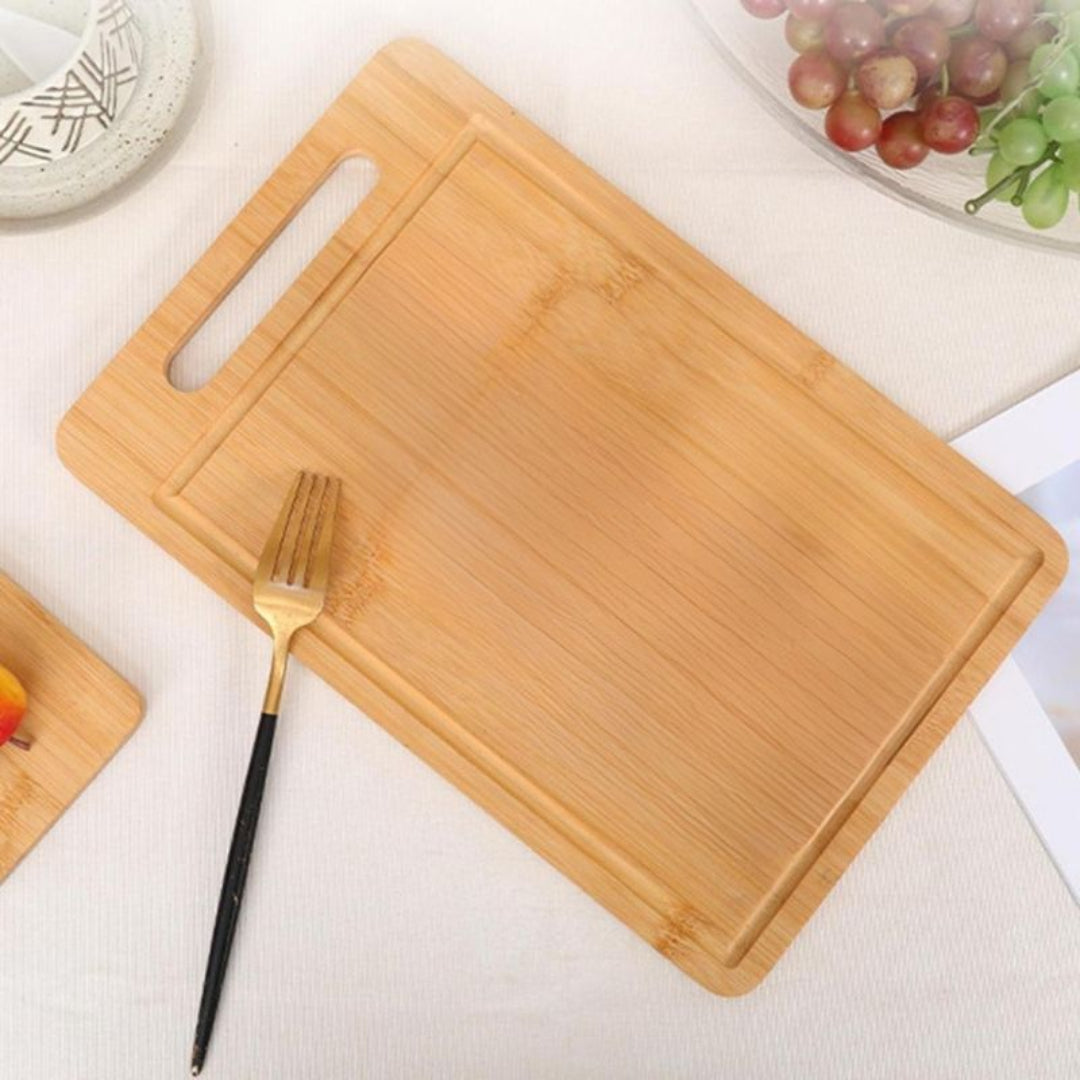 Wooden cutting board with a fork on a light surface