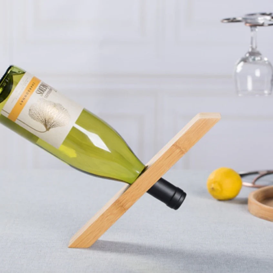 Wooden bottle holder with a wine bottle on a light gray surface