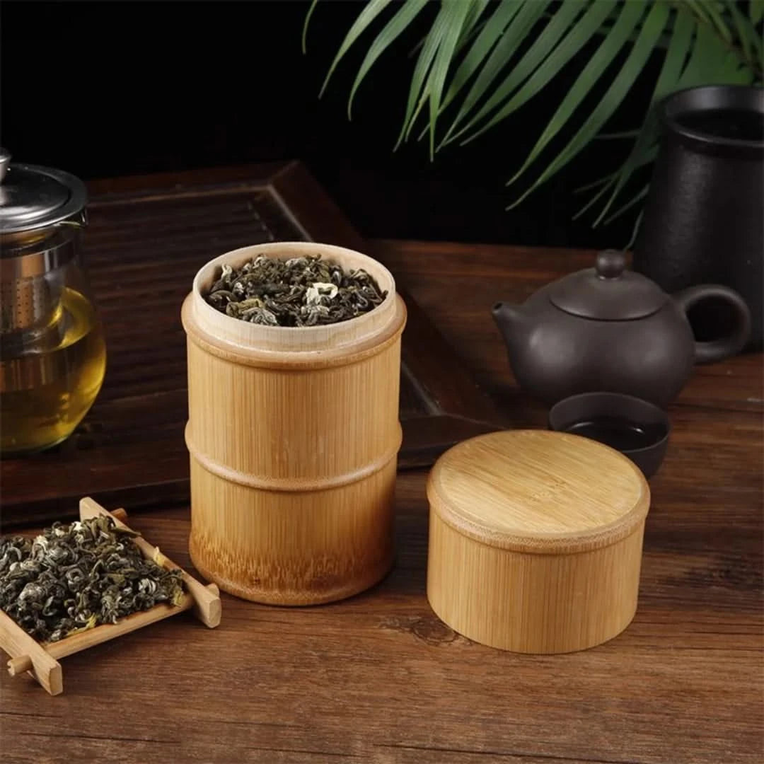 Josh & Tate - Bamboo Food Storage Container - Bamboo container with tea leaves on a wooden table with tea-making items.