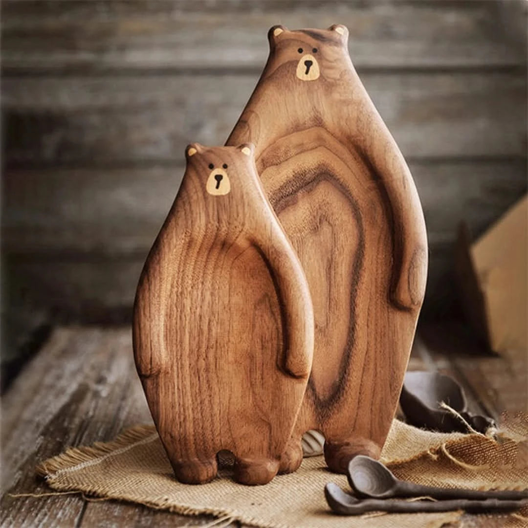 Josh & Tate - Bear Wooden Serving Board - Two wooden bear figurines on a rustic wooden surface with a blurred background.