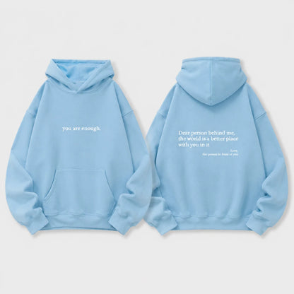 Josh & Tate - BehindMe™ Quote Hoodie - A light blue hoodie shown from both the front and back on a light gray background. The front features the white text 'you are enough.