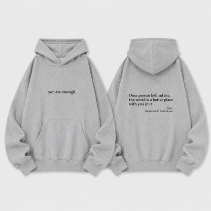 Josh & Tate - BehindMe™ Quote Hoodie - Two light gray hoodies shown front and back on a plain light background. The front hoodie has the phrase 'you are enough.