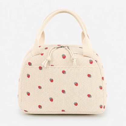 Josh & Tate - BerryTote™ Insulated Lunch Bag - An off-white corduroy lunch bag with a small red strawberry pattern, featuring dual top handles and a drawstring closure.