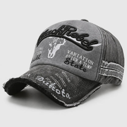 Josh & Tate - BlackRebel™ Distressed Cap - A distressed gray baseball cap with black and white graphic text and embroidery, including 'RustRock' and 'Vartation After A TMR Skate'.