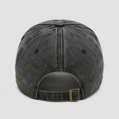 Josh & Tate - BlackRebel™ Distressed Cap - Rear view of a dark gray washed denim baseball cap with an adjustable strap and a gold-tone metal buckle, shown on a light gray background.