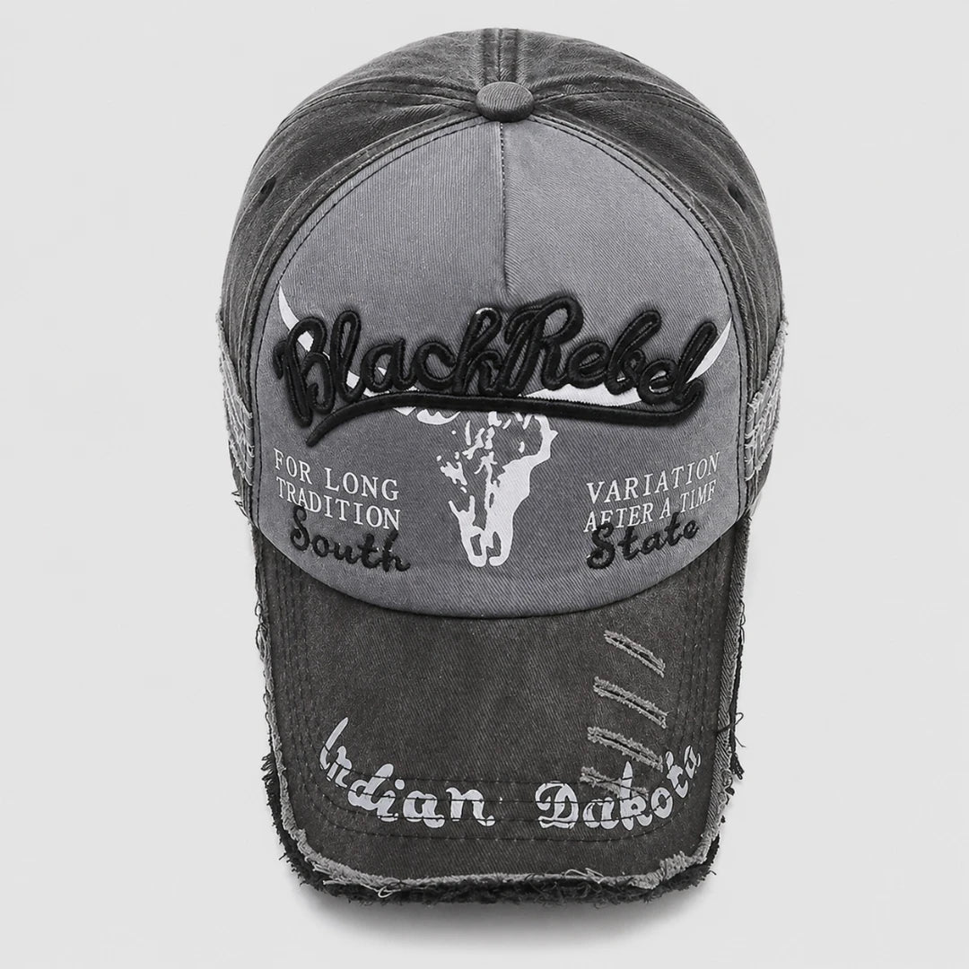Josh & Tate - BlackRebel™ Distressed Cap - A distressed black and gray baseball cap with embroidered details, featuring 'Black Rebel' on the front, a white skull graphic, and 'Indian Dabber' on the brim.