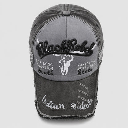 Josh & Tate - BlackRebel™ Distressed Cap - A distressed black and gray baseball cap with embroidered details, featuring 'Black Rebel' on the front, a white skull graphic, and 'Indian Dabber' on the brim.