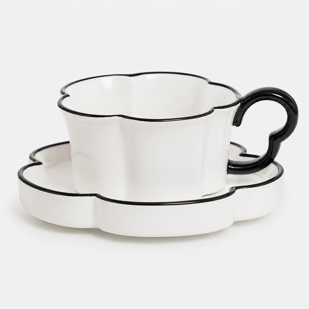 Josh & Tate - BloomCup™ Porcelain Cup & Saucer - White ceramic teacup and saucer set with black scalloped edges and a black handle, photographed on a clean white background.