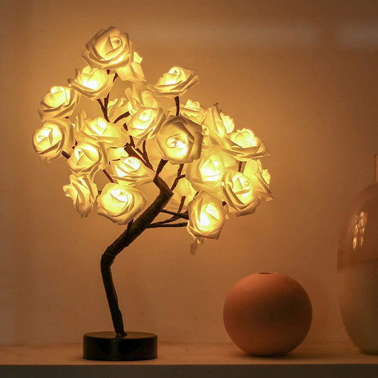 Decorative LED tree with illuminated roses on a plain background