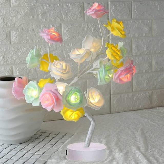 Decorative lamp with colorful flowers on a white brick wall background