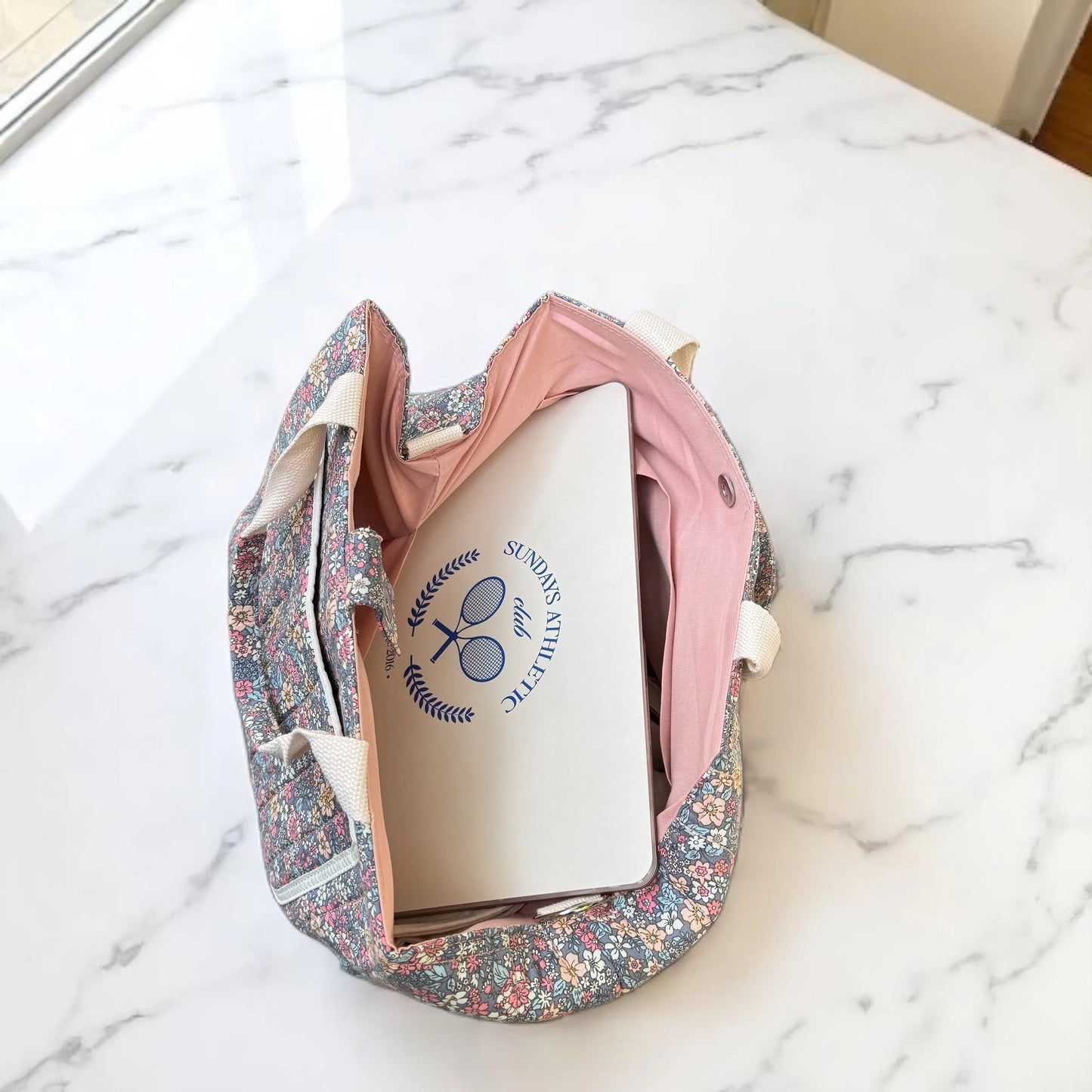 Josh & Tate - Blossom Tote Bag - Floral-patterned shoe bag with a white shoe inside on a marble surface